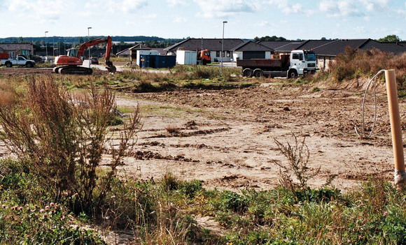Her mellem lutter nyt byggeri er en sydvendt mark ved at blive til et nyt boligområde. (Solbjerg)
